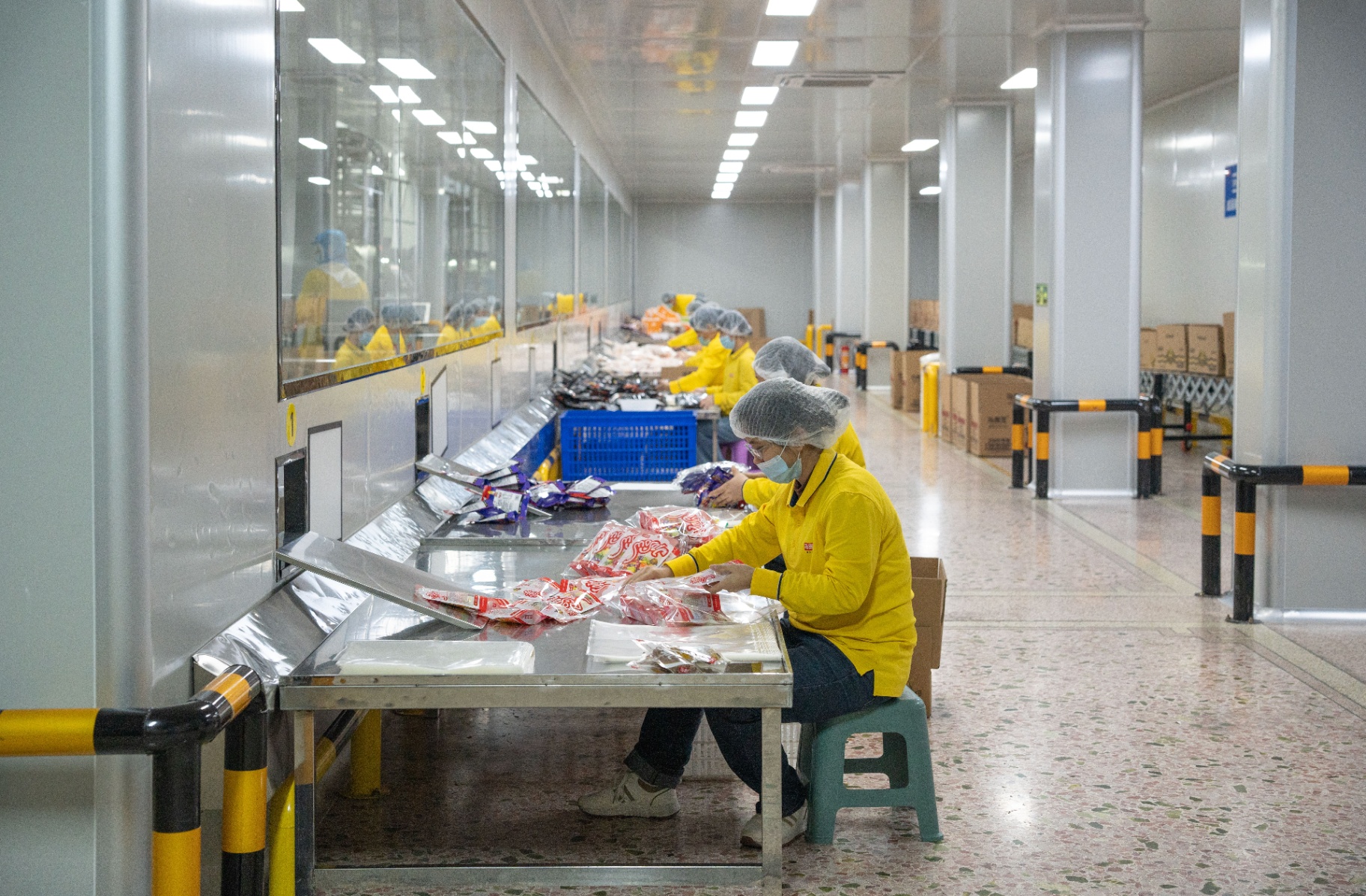 Workers packaging products in MOSAIC's factory